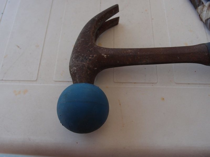 A "clown nose" made from an old handball allows you to use your regular hammer to pound in stainless or titanium,  interference-type, glue-in bolts.  I used an oiled razor knife to cut the hole.