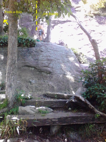 Near base of Peek-a-Boo. It's to the left of him up a short scramble about 20 feet. He is standing right at the base of Jim Dandy. <br>
These 3 wooden steps are the only wooden steps on the trail for Table Rock, so they are a good landmark for finding other routes.