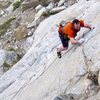 Trying hard to not whip off the crux on the first ascent.