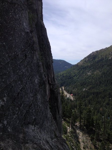 The traverse from North Face anchors. Down and to the right, then up the featured column to the bushy ledge.
