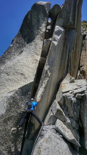 R Shore entering the "4th  class" crux on the SW Arete of Grizzly Peak. Photo J McKee