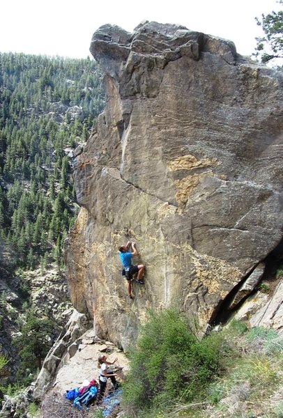 Near the end of the opening boulder problem.