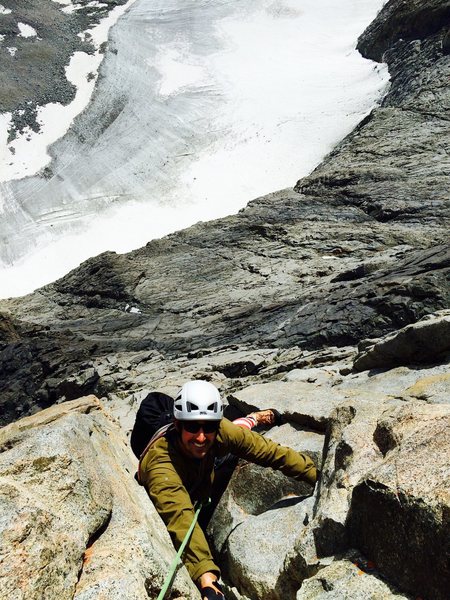 Mark Collar following the crux pitch with the Norman Clyde Glacier dropping away 1,000 feet below