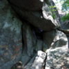 Another view of the Flintstone. Only one climb currently. Start up the ramp on right and move up an left, climbing the weakness up the suspended boulder. Called "Yabba Dabba Doo"