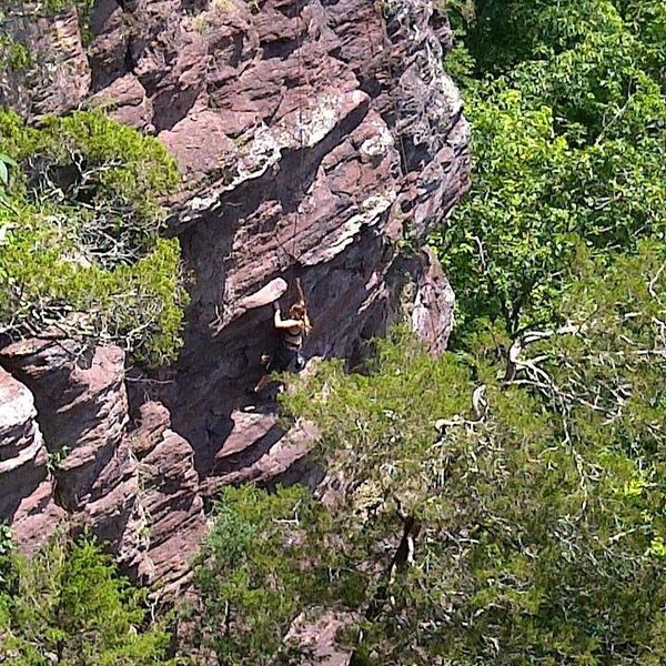 A picture from above of me climbing this beast. I would honestly rate it harder for short people like myself because some of those holds i was lunging across the rock to.