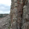 Instead of heading left and north at the end of the fixed line, head south a short distance over a small hump of talus to be treated with this view of Swift Spire and the three fine lines it sports.