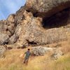 Massive caves high on the hill... photo of climber running away from massive hidden bear cave 