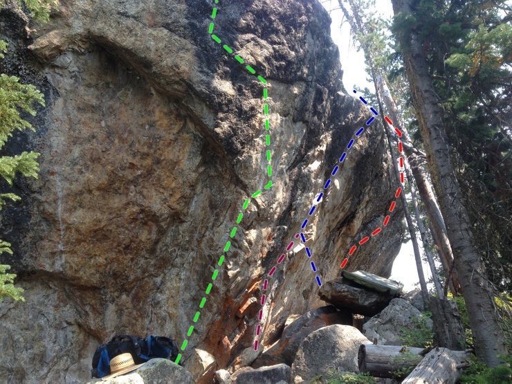 SW side: <br>
Red = V5: S. Face; steep boulder problem, top rope or pads, spotter, brush for lip, jugs to small hold to lip maneuver. 4.5 m <br>
Blue = 5.10: (5.11d SDS); common free solo; very steep, big holds, lip crux, classic, above talus. <br>
Green = 5.13- Collins: Hanging Arete, undercling, long move left, 1 bolt + small tree anchor. Slings. <br>
