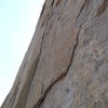 The '13b' pitch. Strenuous traverse along the undercling flake, leading to the cruiser vertical crack. The crux comes near the top of the crack as you step left and pull through some small crimps and sidepulls.