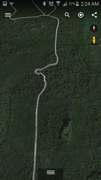 Travel on Forest Service 1544 Rd. for 1.6 miles. As pictured, you will wind through this hairpin turn, and the road will go downhill a bit.