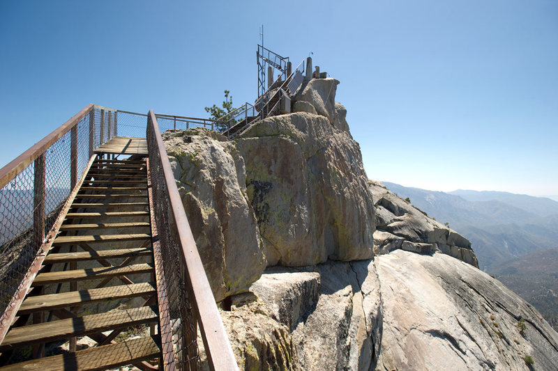 Currently, the stairs up to the fire lookout end abruptly, where the lookout once stood. There is 15 feet of 5.2 slab climbing from the last step to the top of the formation.<br>
<br>
For those climbing the Magician, it is now possible to walk down the stairs at any time, 7 days a week.