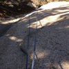 Looking down at the crux slab.