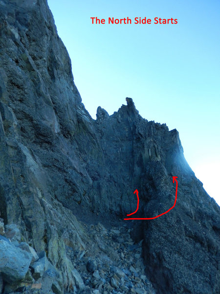 Start in a small alcove below the notch. Either go directly up cracks, 5.7/8. Or travsre right around on easy rope drag rock 5.4.