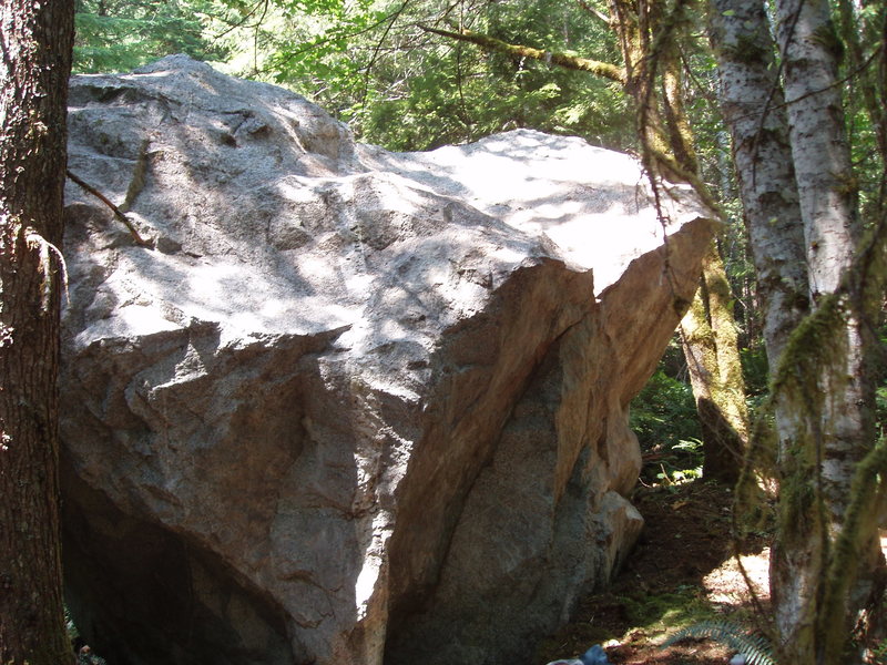 David Tower and I scrubbed this one off about 5 years ago, and called it the "Monkey Joke Boulder".  It's on the main trail to Spring Mountain, and may be the same as the "Unknown Boulder" on your map.  <br>
<br>
We were naming the L-R traverse in the picture "Is this going somewhere?", but neither of us ever linked it.  Start on the L; top out when you get to the notch near the R. It's not too hard; maybe V4, and it's a great safe line.