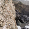 The route starts from the main boulder off in the distance and traverses left to access the left routes. 