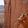 Mary Eden onsights Run Like Hell, a fun traversing 5.10 crack at The Wall, with North Six Shooter in the distance.<br>
<br>
Photo by www.danafelthauser.com