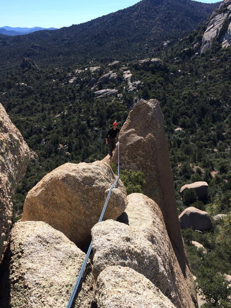 Joey D. mid-way through the 2nd pitch, about to downclimb to the right and traverse to the tree where the photo was taken from.