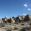 The north end of Grain Central Station, Joshua Tree NP<br>
<br>
A. Staircase Crack (5.4)<br>
B. B.M.T.C. Leader (5.7 R)<br>
C. Snoops (5.6)<br>
D. Dancing on Dimes (5.7)