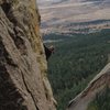 Sharon cruising her way to a flash send of Golden Goat. The NW face of the Slab can be seen way below us in the lower right portion of picture.