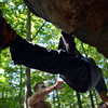 Mel Rivera hanging, foot flagged while bouldering "Ice Cold" a V7 traverse at Nine Corners Lake in the Adirondacks of NY. <br>
Read More - http://www.timetoclimb.com/bouldering/boulderingintheadirondacks/