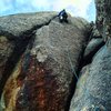 Ted Smith leading.  Note gear placed above the bolt to protect the traverse to the first bolt--as the fall would be unacceptable otherwise before the first bolt.  Large gear (4 inches) needed below and to the right (out of picture) to protect the anchor for the belayer.