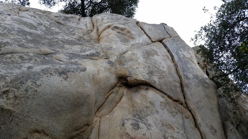 The namesake of the Y-Crack Area. Butthole Express (5.8) is about 15' to the left of the Y-Crack and has boulders for natural anchors. Y-Crack (5.7) has 2 bolts. The Chimney (5.3) and The Flake (5.6) are to the right by the tree at the base of the wall that you can see in the photo. 