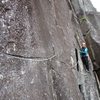 From the top of Pitch 1 of Godzilla, you can traverse out right to a chimney system onto a route called "Park Ranger". Park Ranger is not on the original topos, but it gets climbed on occasion. This photo shows Cat at the end of the traverse out to the start of Park Ranger....(Note: this is not Leapin' Lizards - Leapin' Lizards is just right of the Godzilla anchors, not way out right where Cat is in the photo).