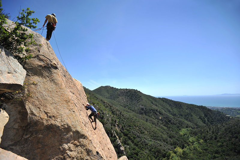 Patrick Callery nears the summit of Fun in the Sun, in Rattlesnake Canyon. Alex Degolia belays.