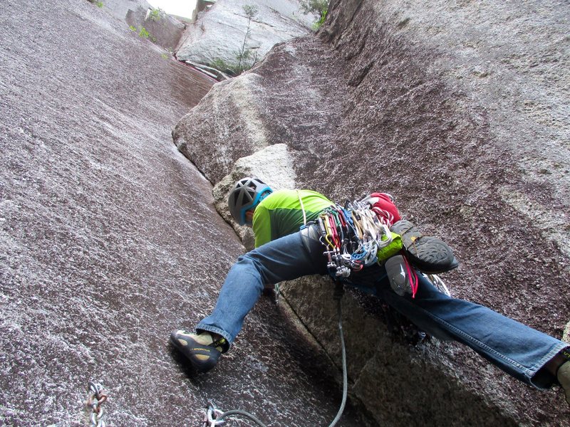 Jon starting up the crux 10a corner pitch of Rock On.