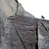 Pitch 3 of The Great Game goes up the 10c corner on the left. The climber in the photo is on The Great Drain which meets The Great Game and then splits off right here.