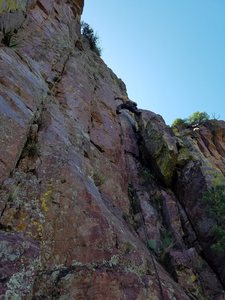 Paul P moving from the dihedral to the face, right below the bolt. Hand crack is above the ledge 