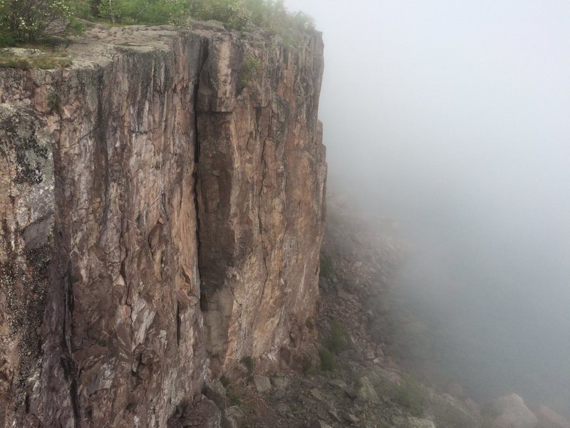 Climber on foggy Superior Crack