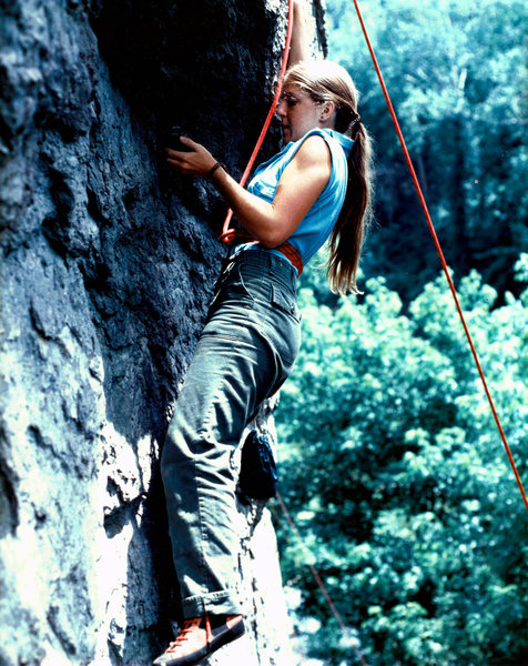 young woman top-roping on Green Bucket circa 1975, or there about. Shoes are "PA"s (Pierre Allains) and the female climber's name is unknown to me. Scanned from an old color print so color of photo- in particular the background- has shifted to an inacurrate hue with time. looking for a similar shot that is a slide and better composition; not a copy.