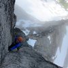 Climber leading Pitch 1 of the Gendarme, with the North Ridge stretching below.