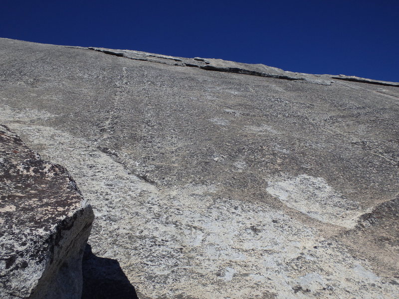 Looking up at P2. You can see the lone bolt on the face before the flake climbing. This is the view from the 1st belay station at the sandy ledge. 