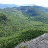 [NOTE: Climbers are at the top double bolt anchor. R Hall NH Admin. This is an excellent photo for finding this not-too-easy-to find anchor. In the photo of RW scrambling down, he is on the "bump" in the "ridgeline"]<br>
Looking down the top "scramble" pitch of Sun and Games.<br>
