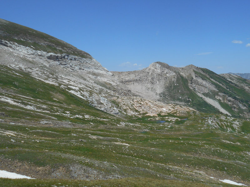 The first pond you pass in Bear Basin.  The chimneys are on the ridge connecting to the small peak on the right.