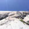 Another view of P1, this one with a climber (Marta Reece) and ropes indicating to show where the route goes. The crux of the route is crossing over the shaded diagonal crack onto the slab proper.