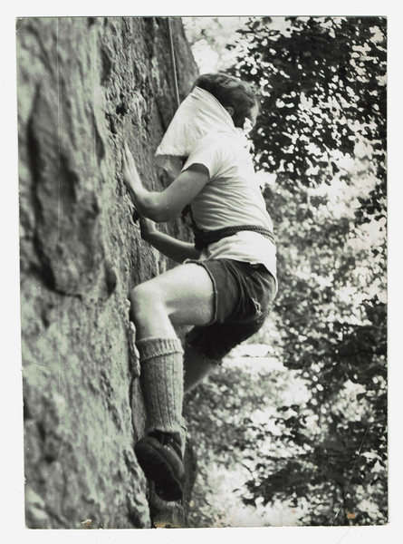 Climbing on the center portion of Nubbin Face blind-folded and against the clock circa 1968-69?. Shoes are "RR" (Royal Robbins, shorts by scissors and Levi Strauss. I am the person in the photo, but i do not recall if the photographer was Richard E. Milller, Dennis Grabnegger, or Joe Ebner.  (it's been a while, and i was blind-folded) just something to pass the time when traffic jams occurred on more serious routes and/or when the route that was  of interest to you was unavailable for whatever reason. it was fun. Guessing, it was 5.2 or 5.3 in difficulty,  and still probably is, even blind-folded; but you did have to change your approach to route finding!