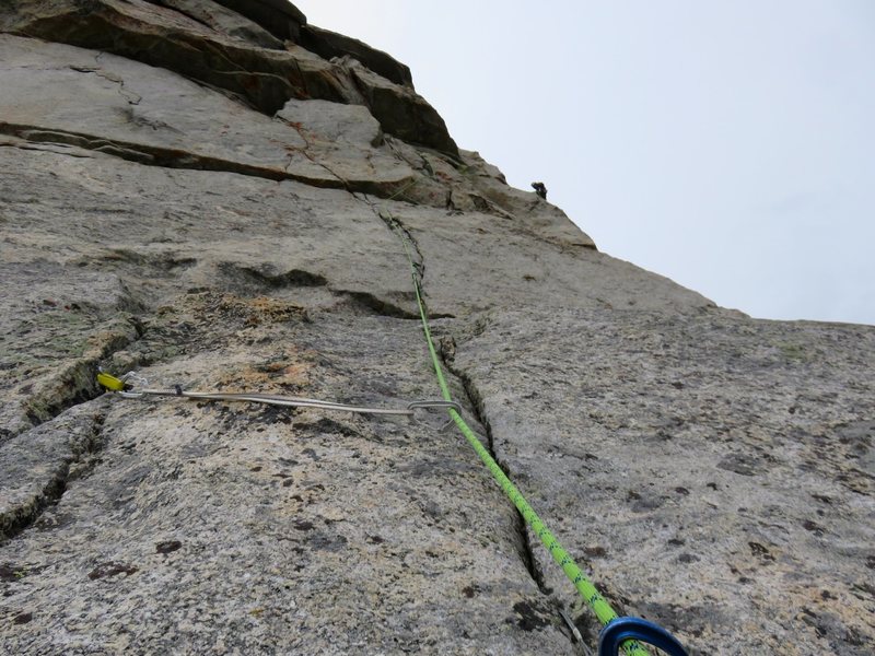 Looking up at Pitch 6, which climbs a thin crack to just below the roofs, then moves right and up to a belay stance. Jeff is actually at the belay near the top of Pitch 7 which is a short traverse further right to the base of a chimney.