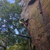 Keith is farther up the arete and is just about to get into the crux.