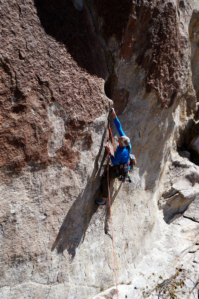 Calvin sticks the crux move on Checkered Demon.