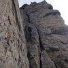 Climber seconding the crux 10th pitch