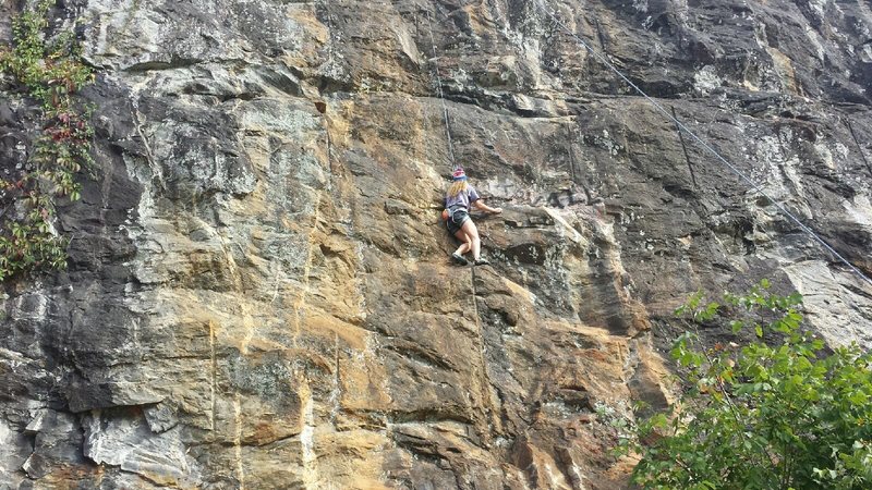 The route can be determined by its yellow color. Here you can see Chloe, a local climber, about 5 feet below the crux.