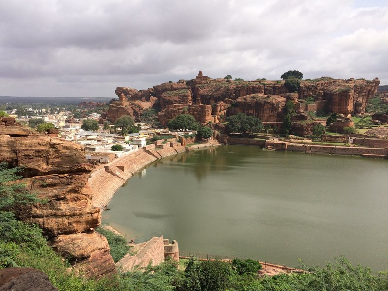 Badami is renowned for its 1000+ year-old rock cut temples sitting atop red sandstone bluffs or excavated into their walls.