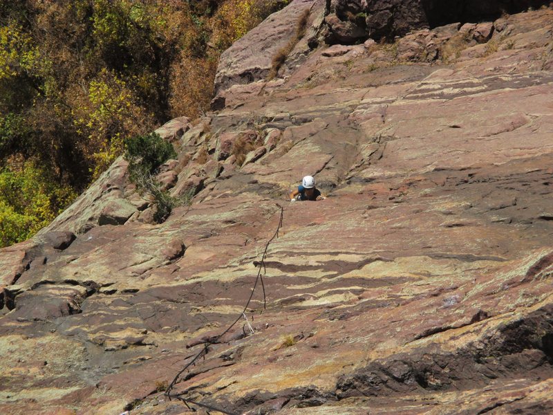 Zoomed in - Joseffa emerges from the Roof Crux on Semi-Wild. The belay is off to climber's right, but one can continue about 100' up to the 2 adjacent pins on Anthill Direct, just below the first roof on that area of the wall, and belay from those and a cam or two.