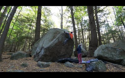 Moving into the crux rockover of 'Boulder X'.