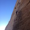 Mae reaching the crux on the Unknown 5.10a/b