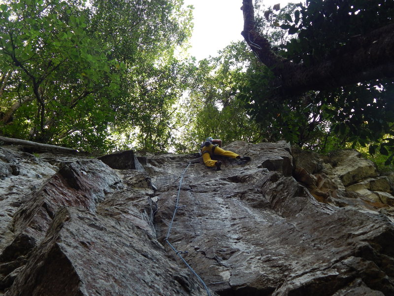 Climber after the crux move to the final slab