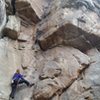 A view up Abeja. The two 5.10-ish cracks can be seen going through the large ceiling above the climber. <br>
<br>
This route is up and right from the Madonna in a large, dusty alcove (bring a rope bag or tarp).